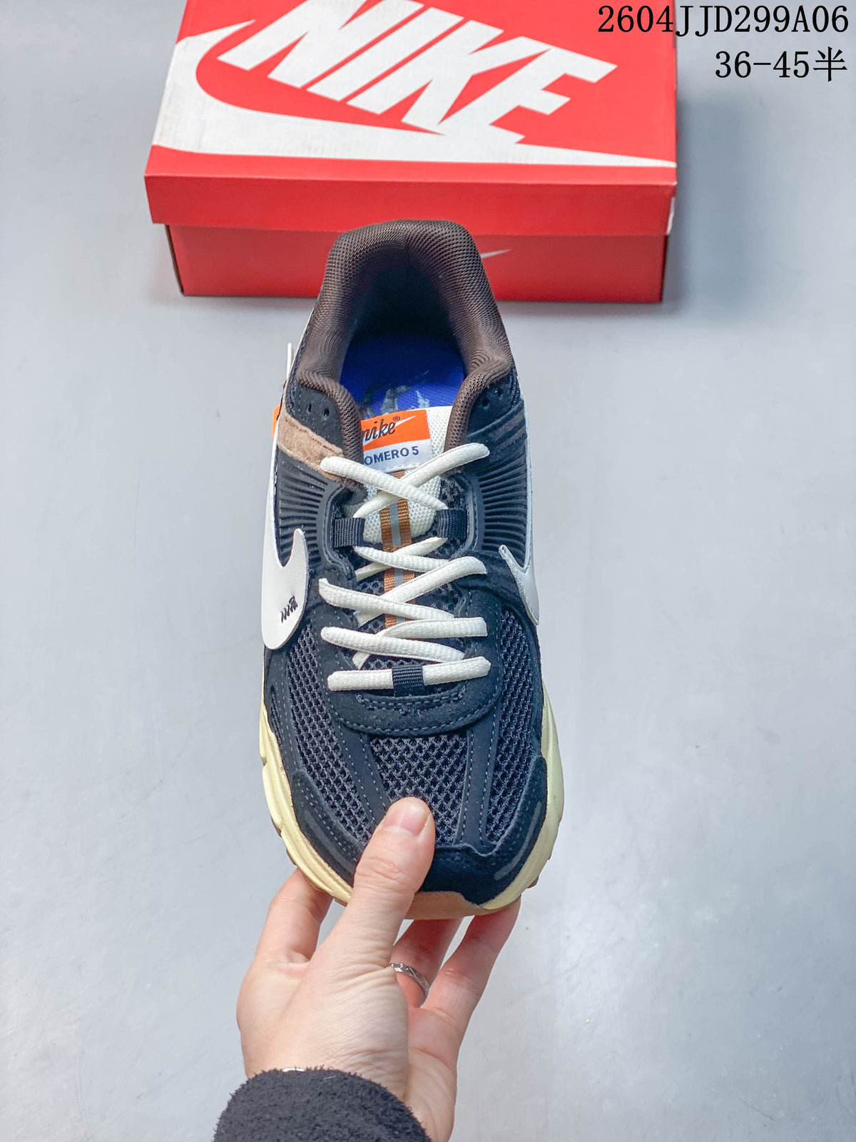 Top view of a navy lace-up sneaker with mesh panels and light laces