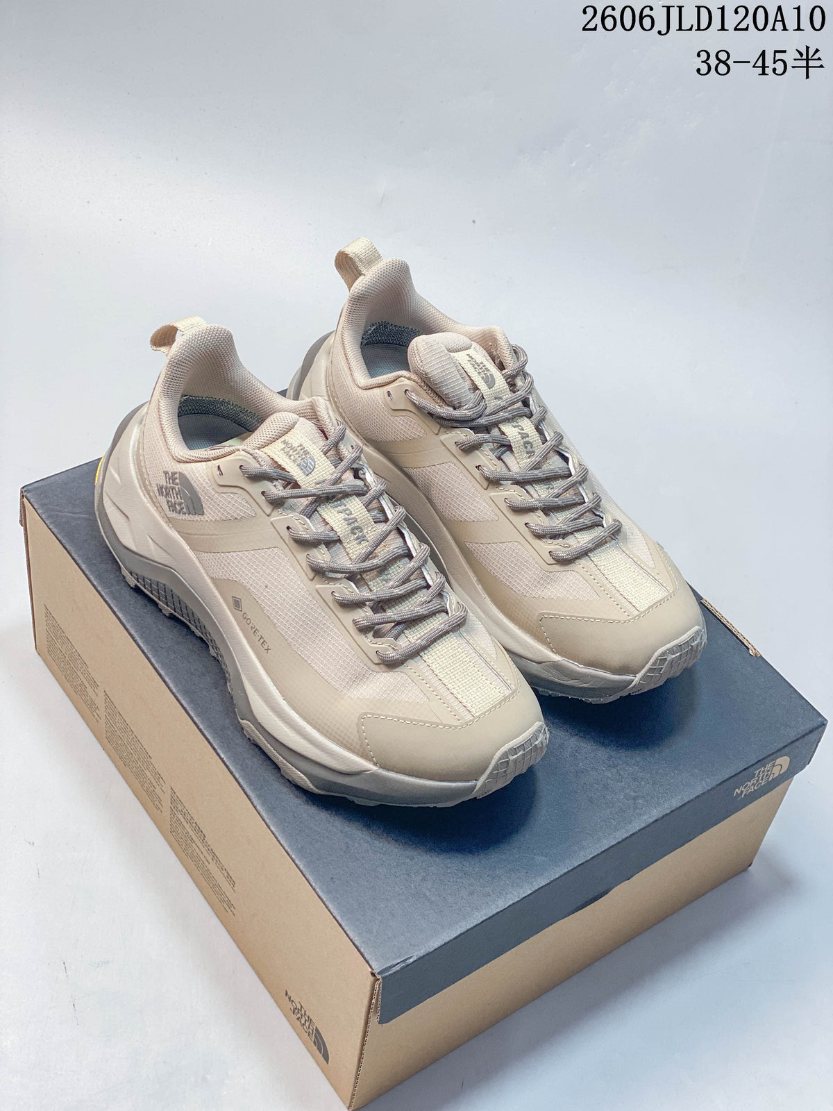 Pair of beige The North Face Fastpack Ultra low-top shoes on a shoebox