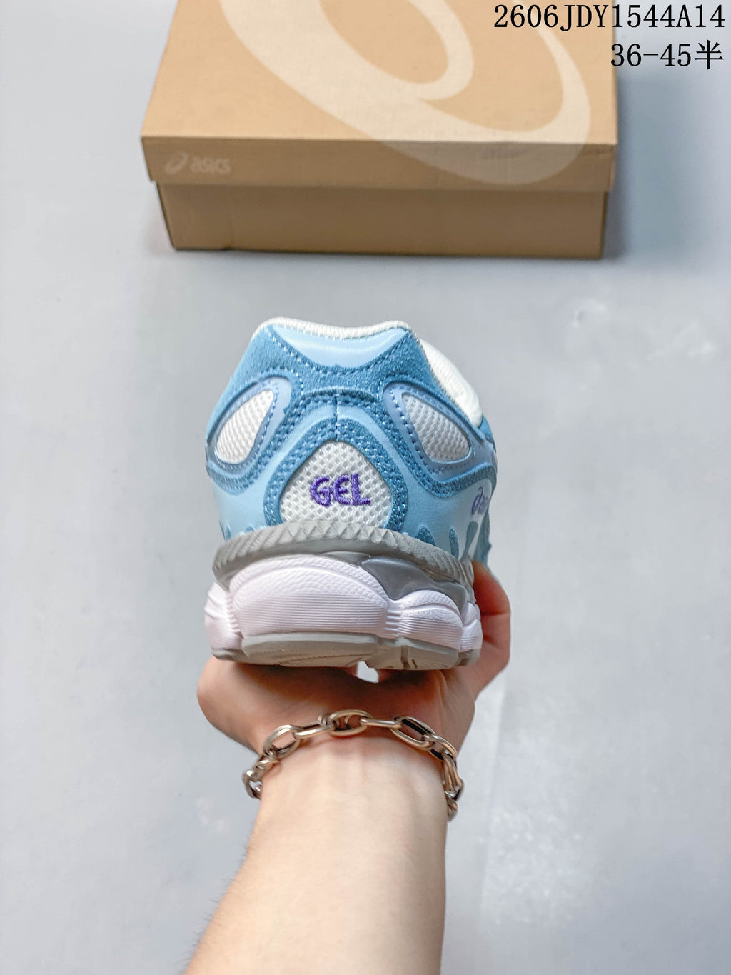 Rear view of the blue and white sneaker showing its heel and sole.