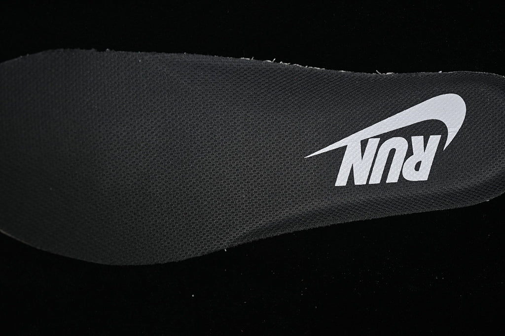 Close-up of the dark shoe insole with a light Nike Swoosh graphic.
