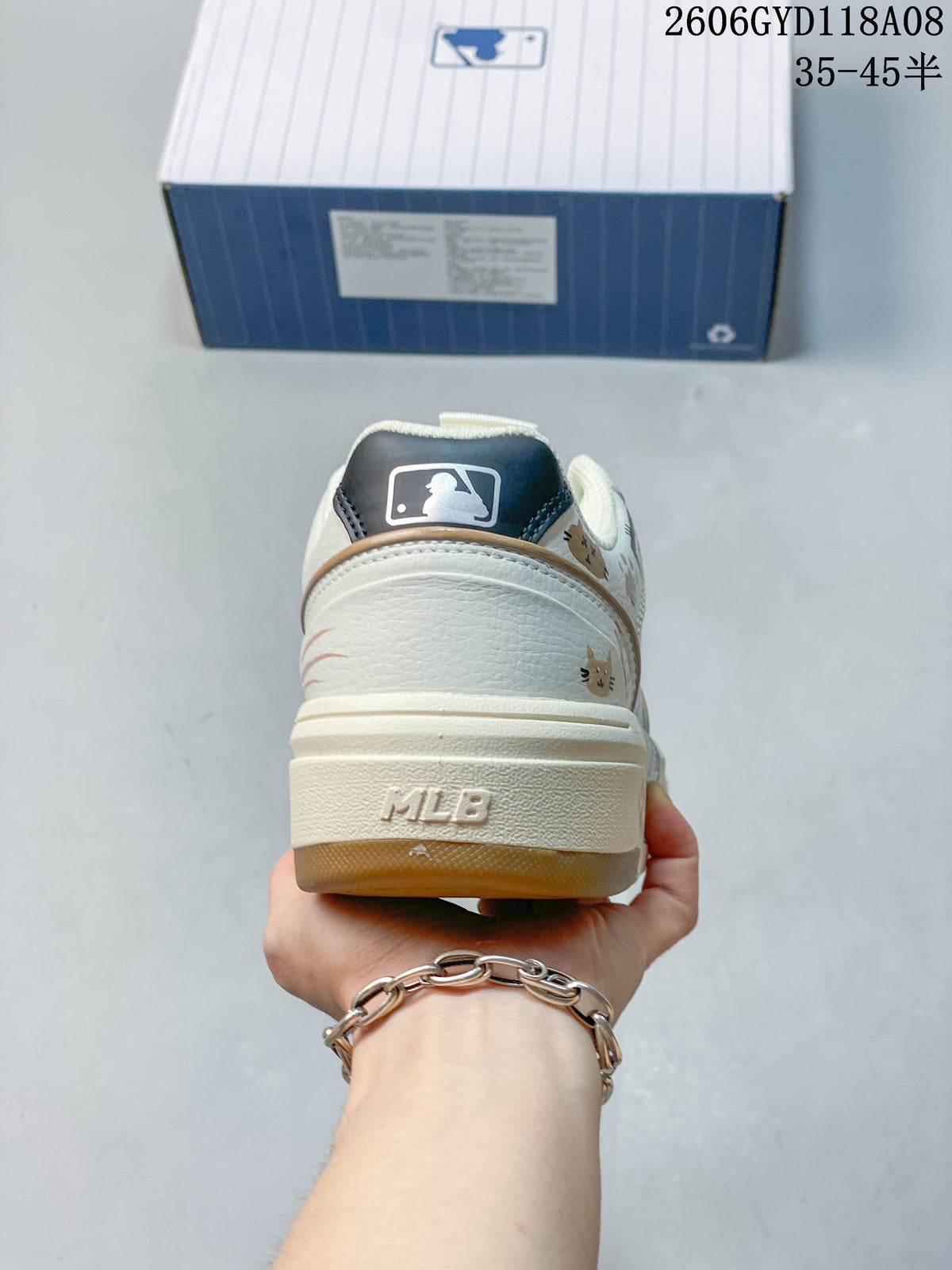 Rear view of the cream sneaker showing the heel and raised MLB lettering