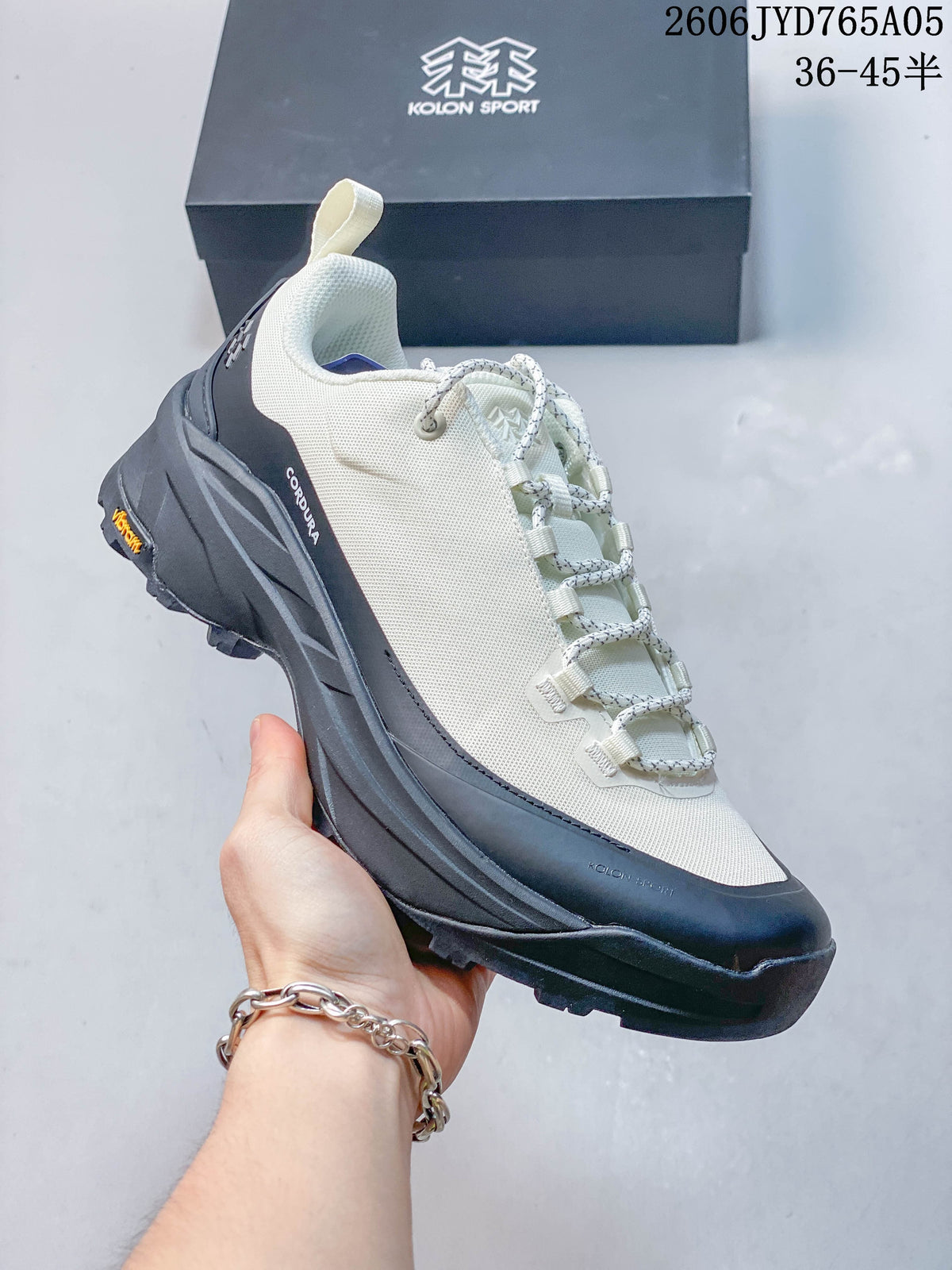 Angled side view showing the mesh-look upper, charcoal overlays and lugged outsole.