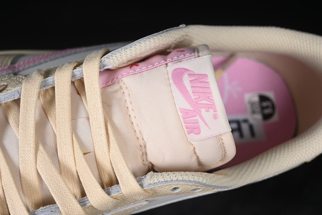 Close-up of the tongue label, laces and pink insole