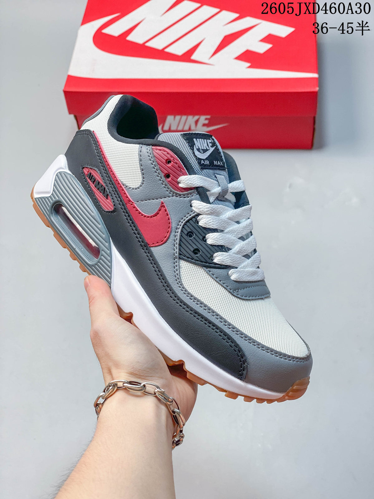 Gray, white, and red Nike Air Max 90 sneaker