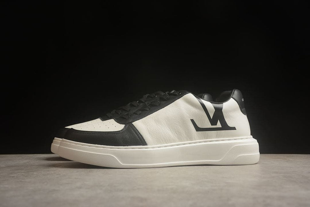 Angled side view of the black-and-white sneaker with a prominent side logo