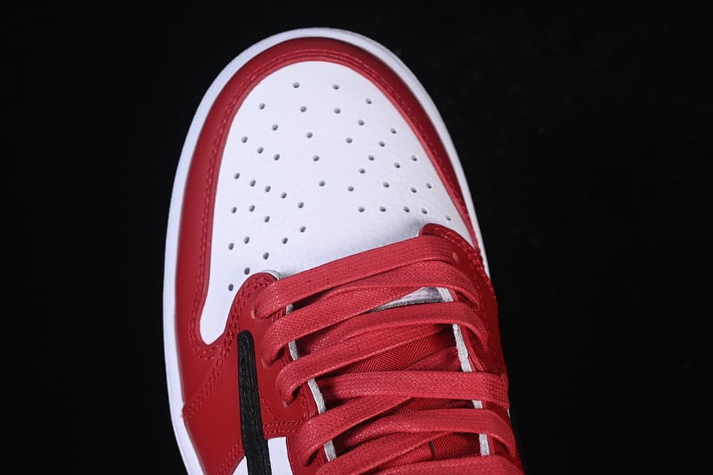 Top view of the perforated white toe and red laces