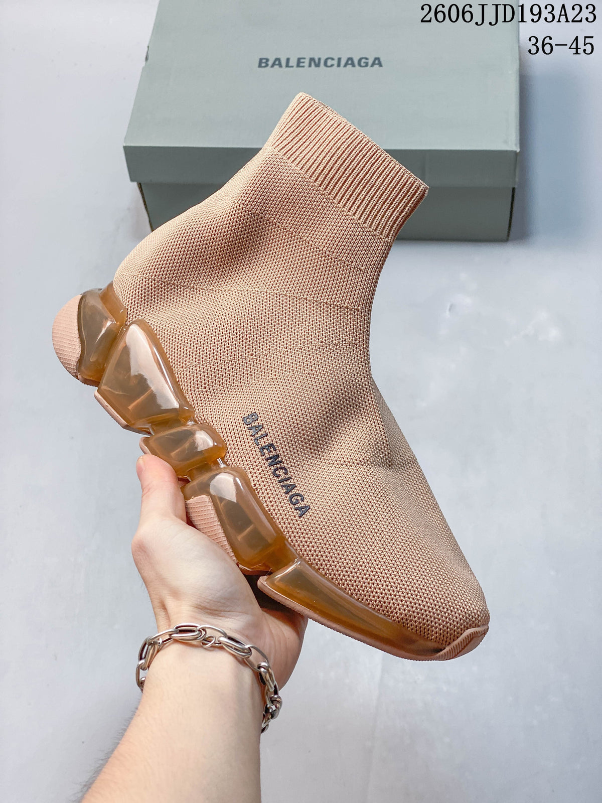 A blush pink Balenciaga sock-style sneaker with amber-toned sole sections.