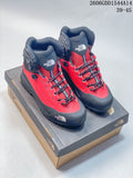 Pair of red and dark gray The North Face Verto Alpine mid hiking boots on a shoebox