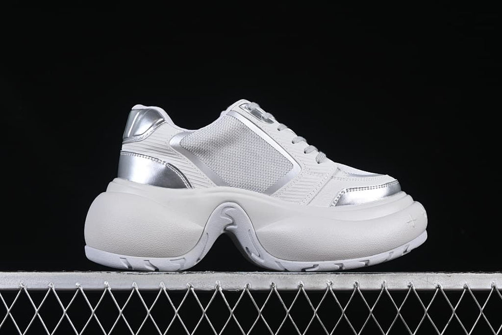 Side profile showing the layered upper and sculpted sole