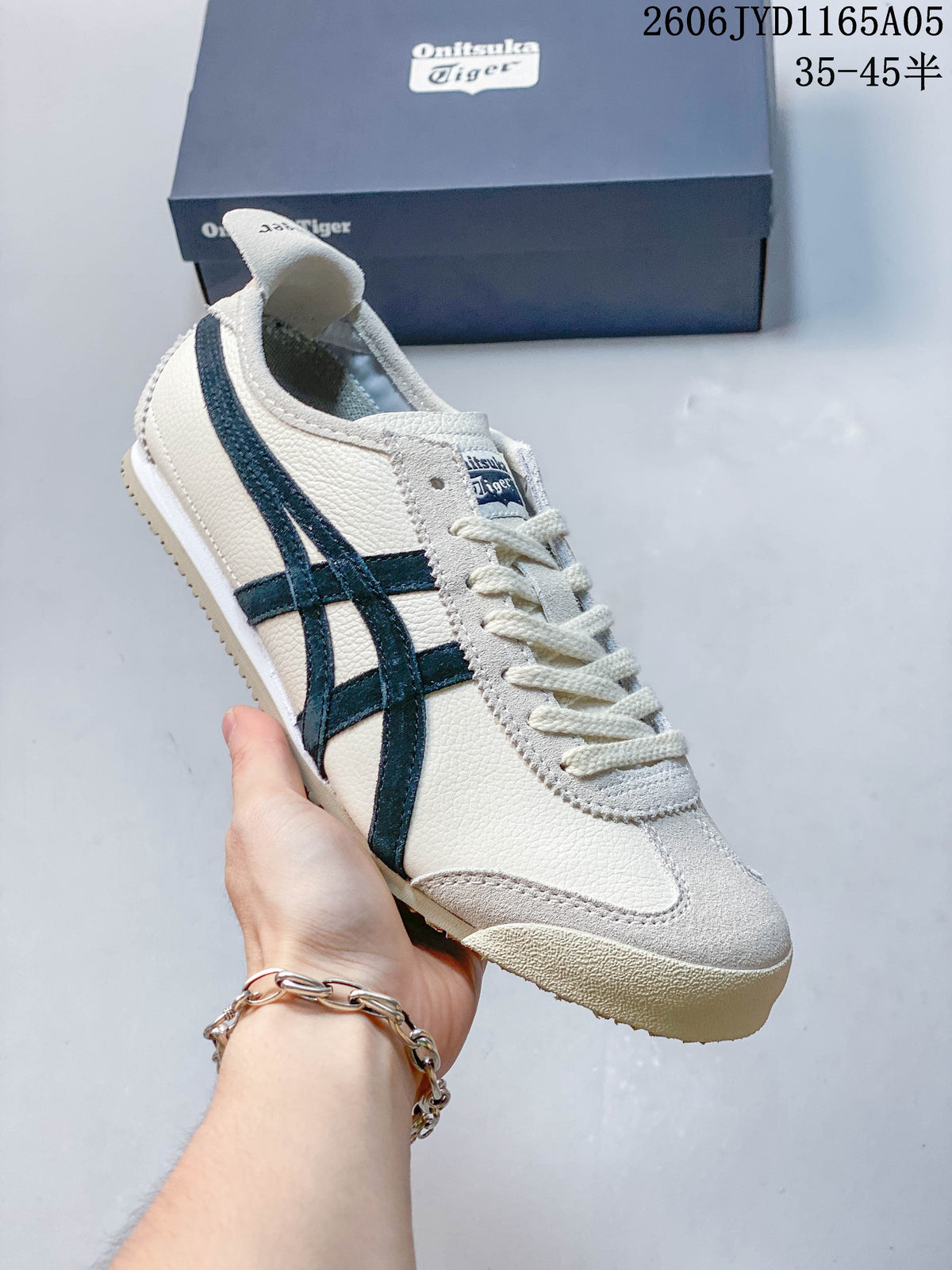 Angled close-up of an ivory-colored Onitsuka Tiger Mexico 66 sneaker with dark navy side stripes.