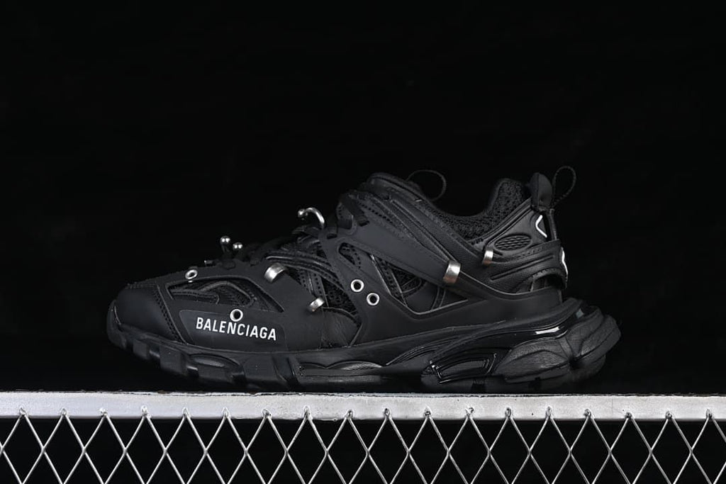 Black Track Piercing sneaker shown in side profile