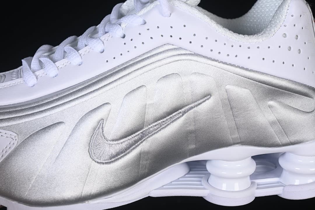 Close-up of the metallic silver side panel, Swoosh, and heel columns