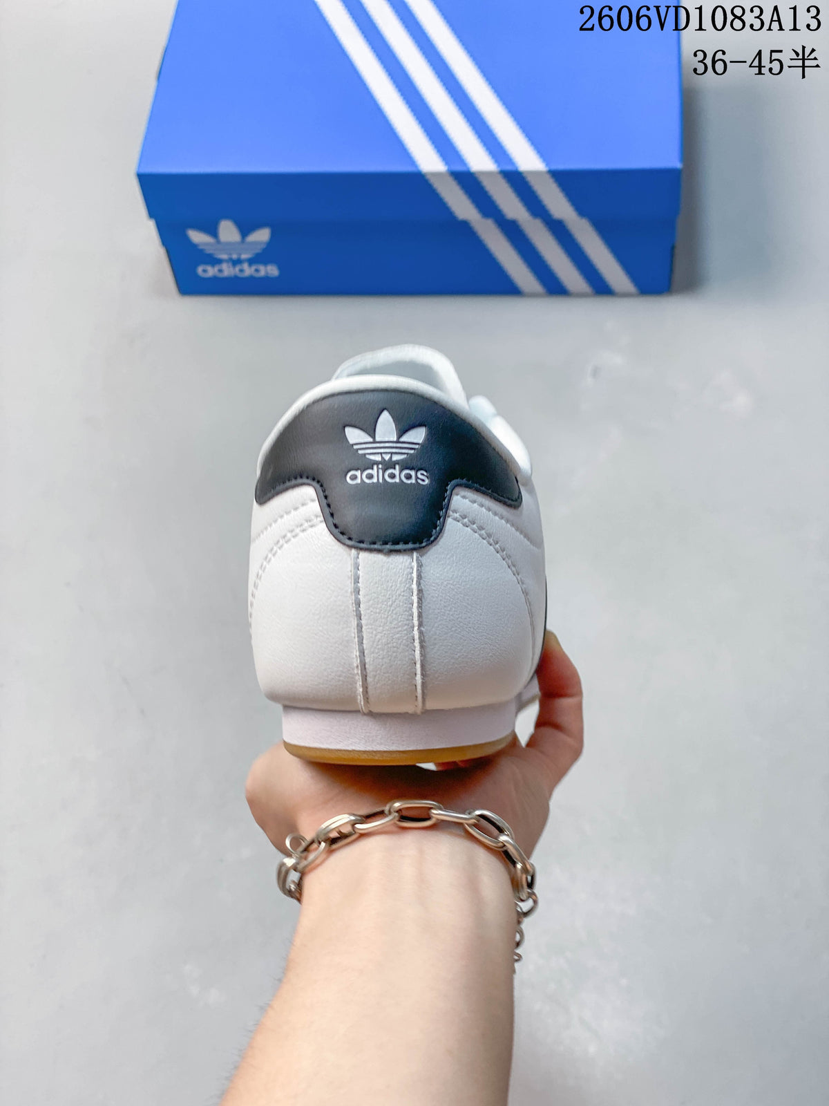 Rear view of a white low-top sneaker with a dark heel detail