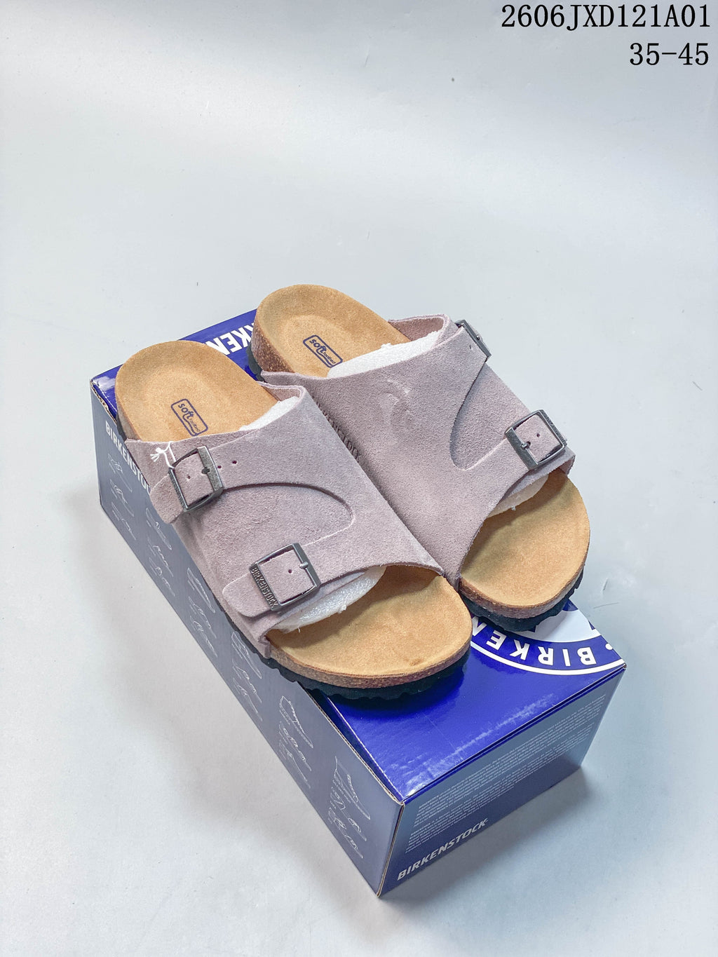 Pair of mauve Birkenstock Arizona BS two-strap sandals on a branded box