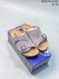 Pair of mauve Birkenstock Arizona BS two-strap sandals on a branded box