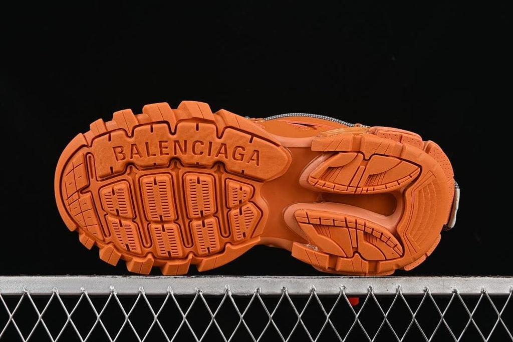 Underside view showing the orange treaded outsole