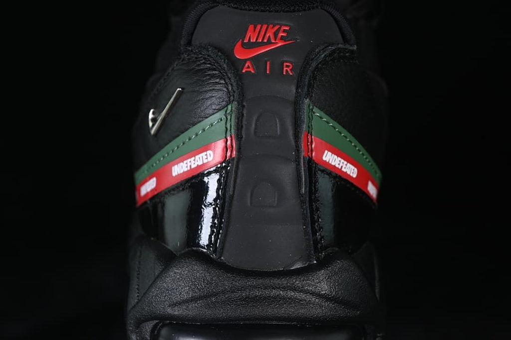 Rear view showing Nike Air branding and red-and-green Undefeated side strips