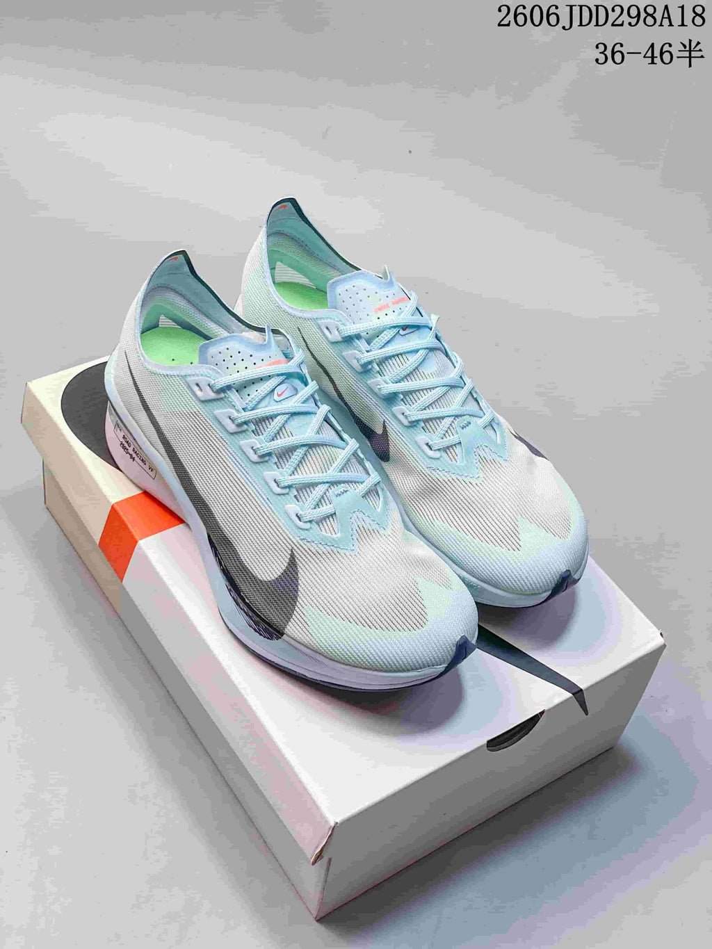 Pair of pale blue and white Nike lace-up road racing shoes.