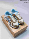 Pair of white, tan, and light blue ASICS Gel-Kayano 12.1 sneakers on a shoebox