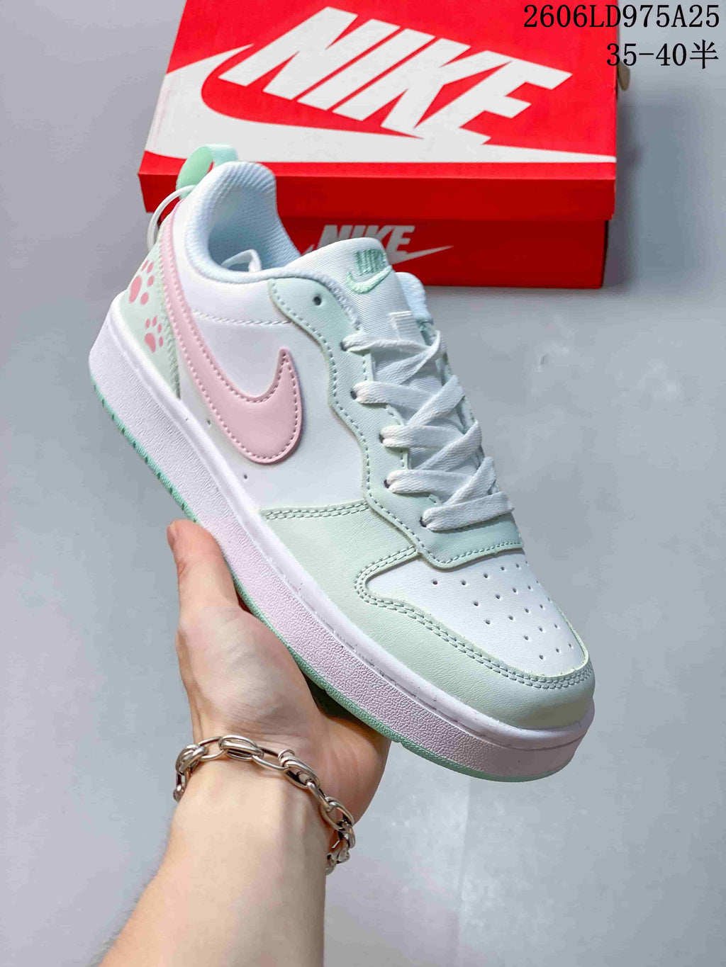 Angled side view of a white Nike Court Borough Low sneaker with pastel accents.
