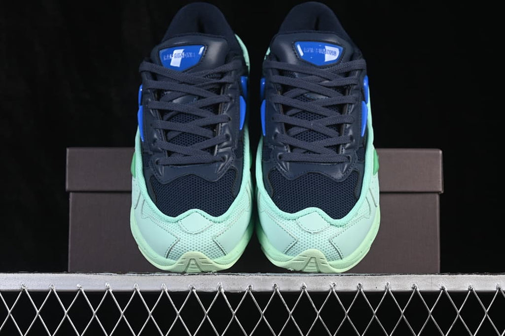 Front view of the navy and mint sneaker pair