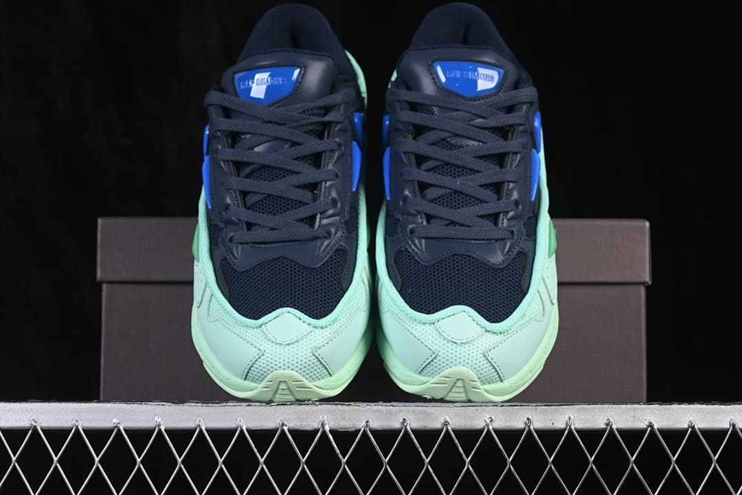 Front view of the navy and mint sneaker pair