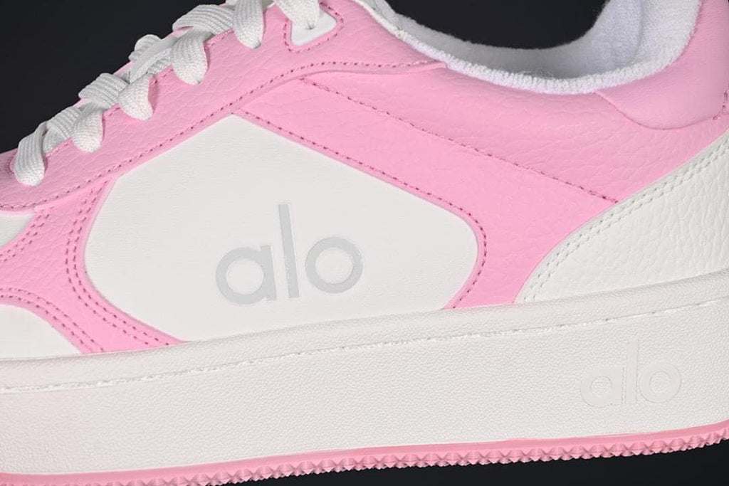 Close-up of the pink side panels, white side insert, and raised sole