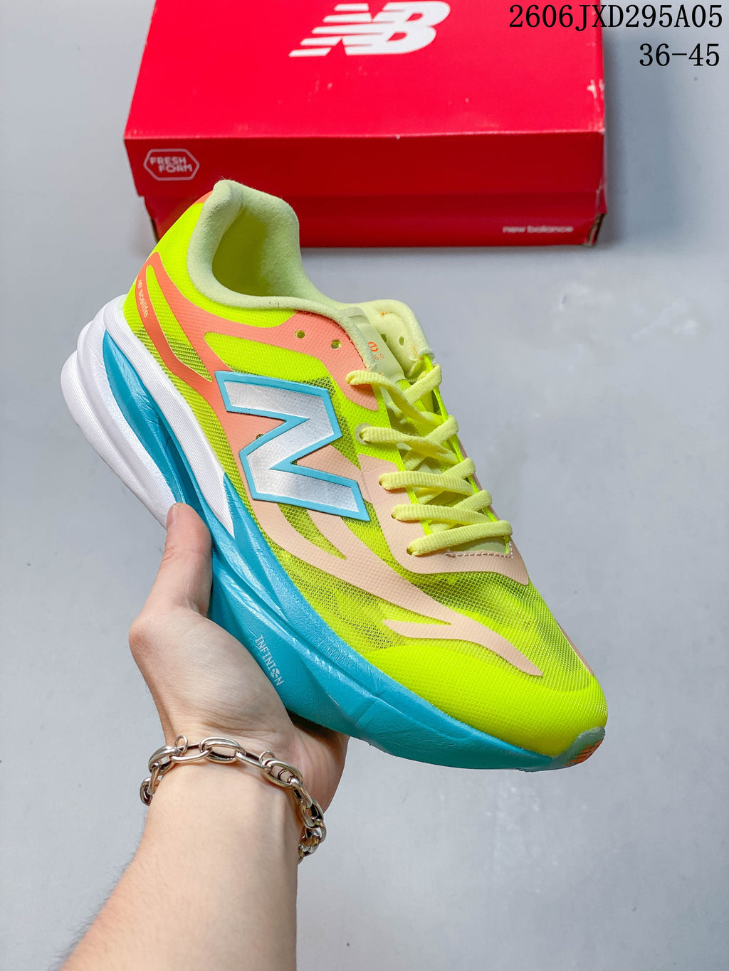 Blue-gray New Balance low-top running shoe with a neon yellow sole accent.