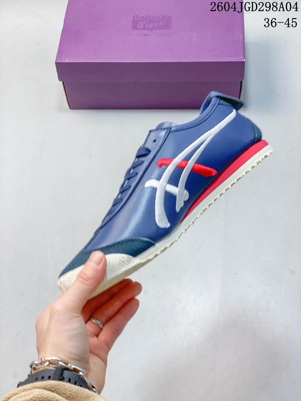 Side view of the blue sneaker with white and red stripes