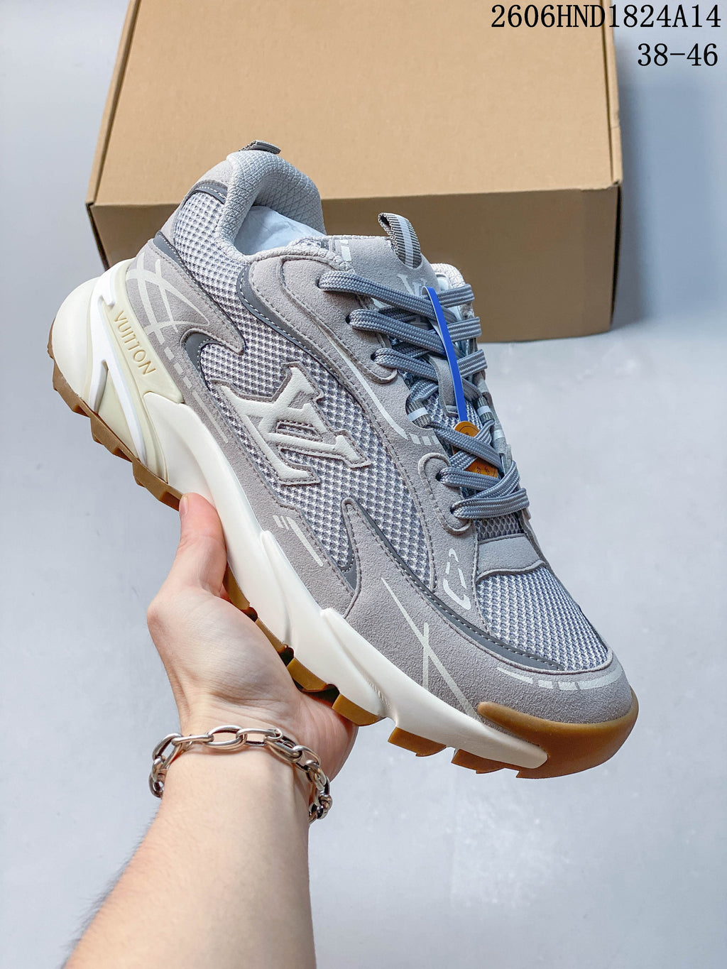 Louis Vuitton Tatic Runner sneaker in gray with a light sole and gum-colored outsole