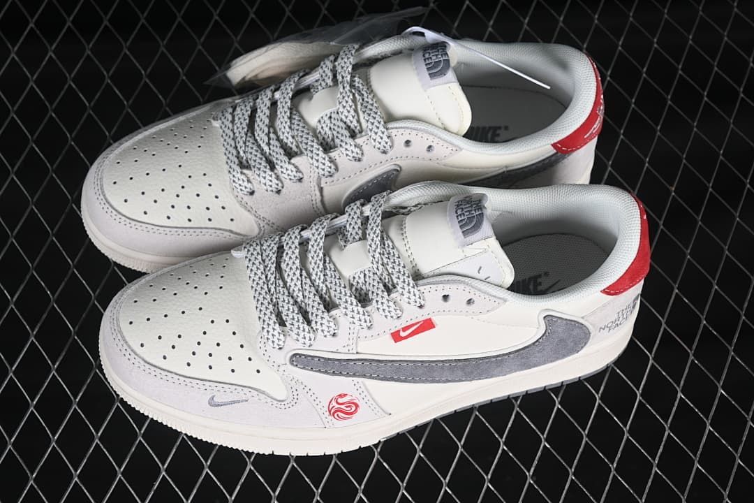 Top view of a pair of cream low-top sneakers with patterned laces, perforated toe boxes, gray side details, and red accents.