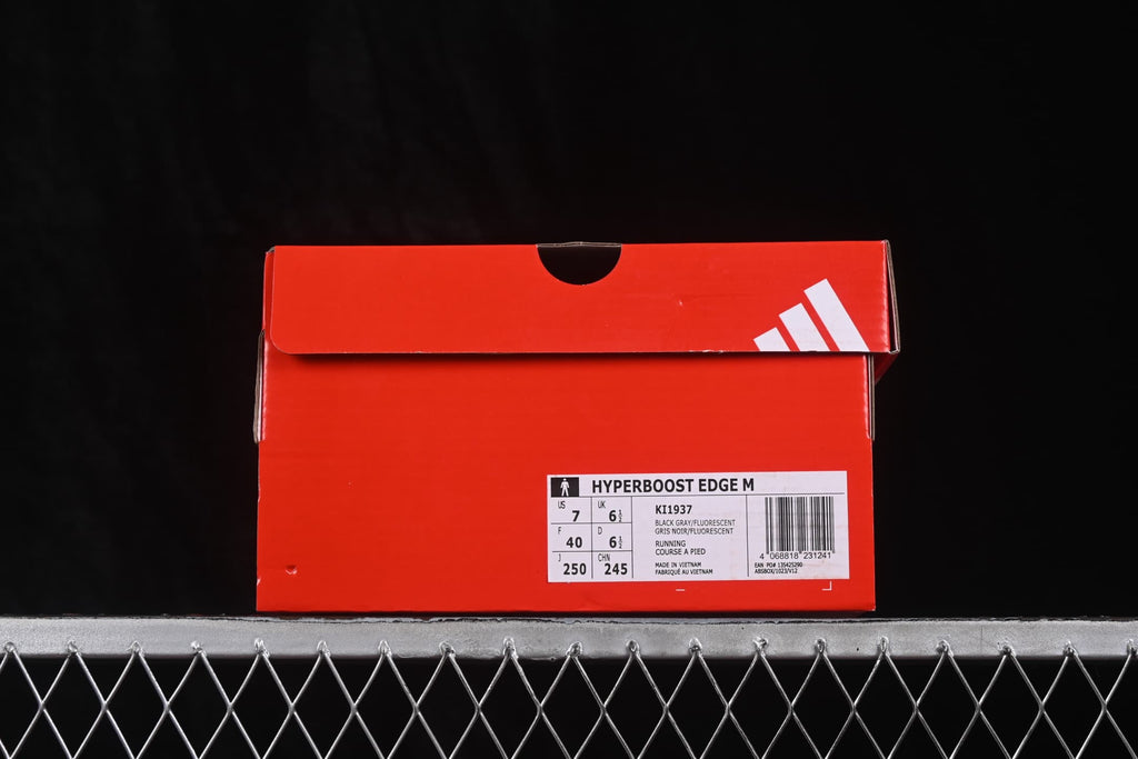 Red Adidas shoe box displaying the HyperBoost Edge M name, KI1937 style code, color information, and size labels.