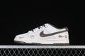 Side view of a white and light gray low-top sneaker with dark brown accents and decorative side graphics.