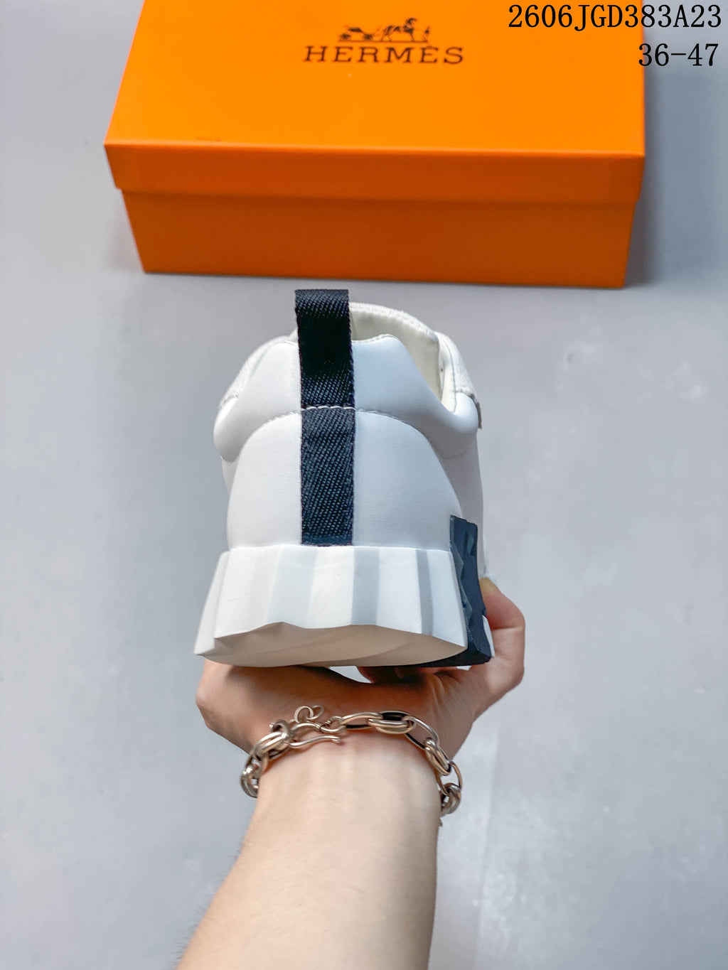 Rear view of the sneaker showing a dark heel pull tab and sculpted white sole.
