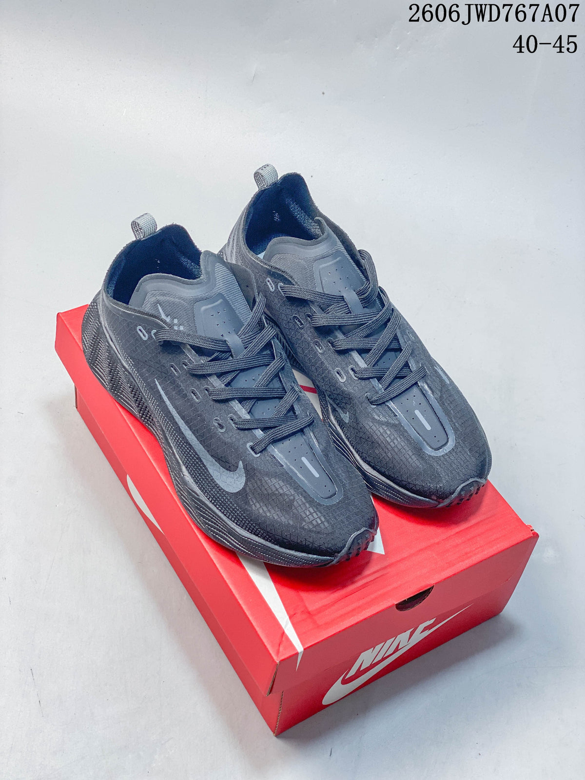 Pair of charcoal Nike Ava Rover low-top shoes with gray Swooshes on a red Nike box.