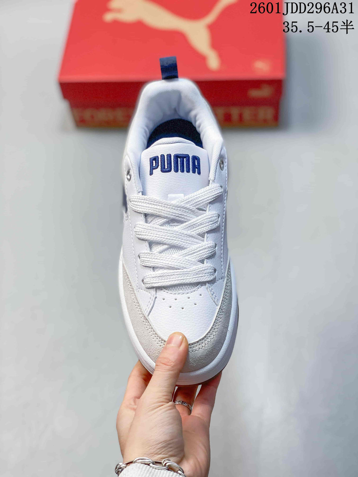 Top view of a white lace-up PUMA sneaker with navy tongue branding