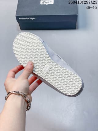 Close view of the patterned outsole on a grey and white Onitsuka Tiger Mexico 66 Sabot sneaker.