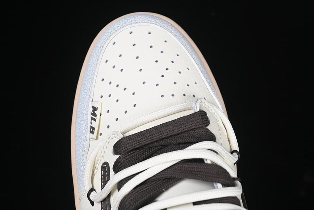 Top view of perforated toe and layered white and dark brown laces