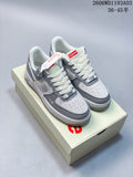 Grey and white low-top sneakers displayed on a branded box