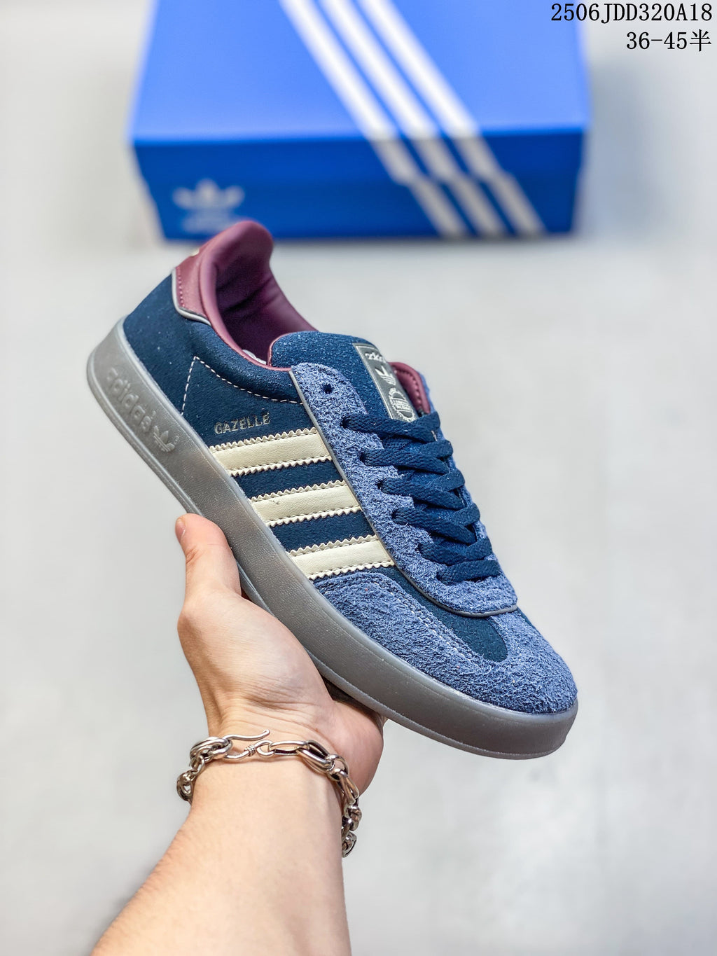 Blue Adidas Gazelle 90 sneaker with cream stripes and a gray sole