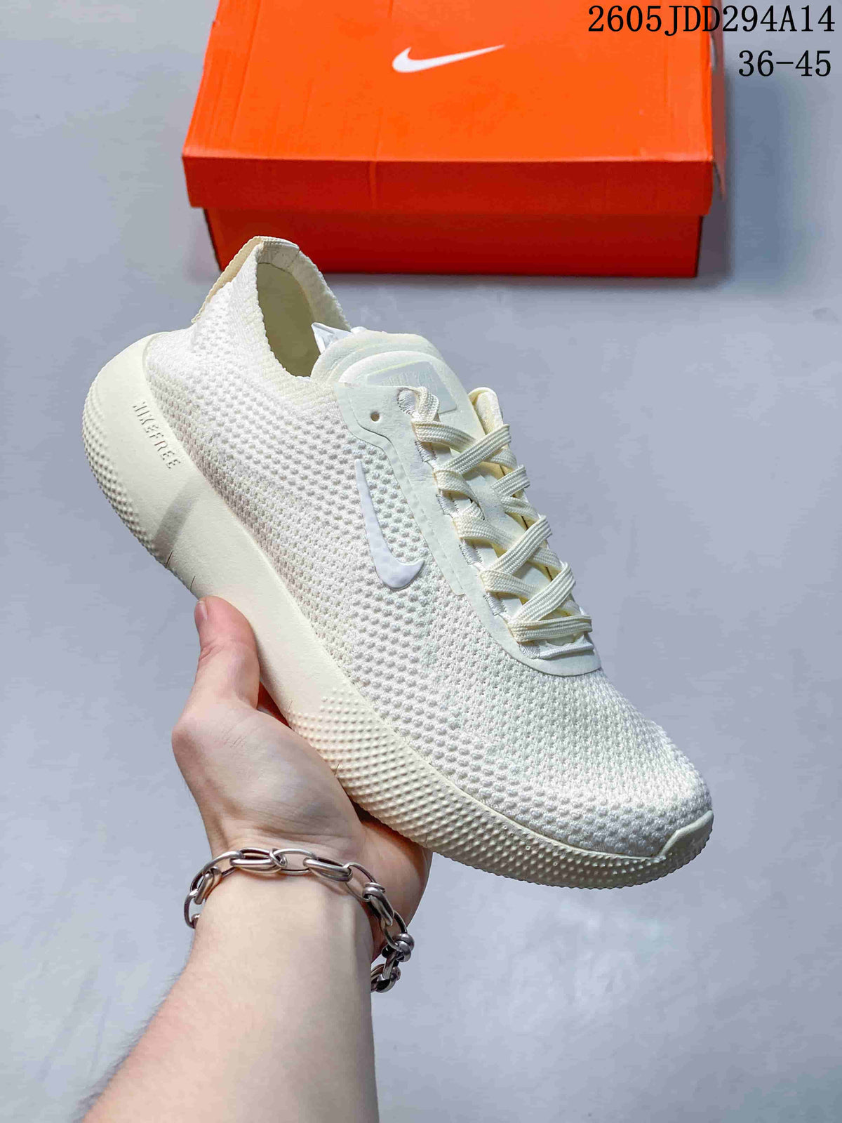 Cream-white Nike Free low-top sneaker with a textured upper and orange shoe box in the background.