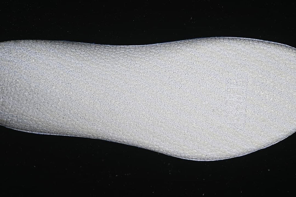 Close-up view of a light-colored shoe component