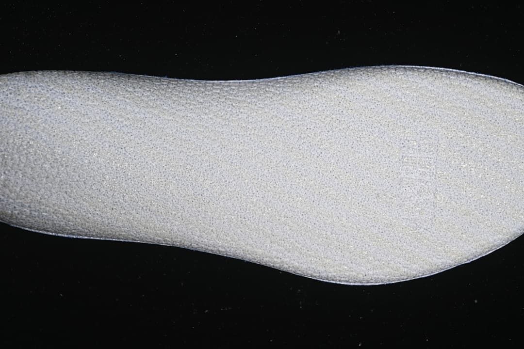 Close-up view of a light-colored shoe component