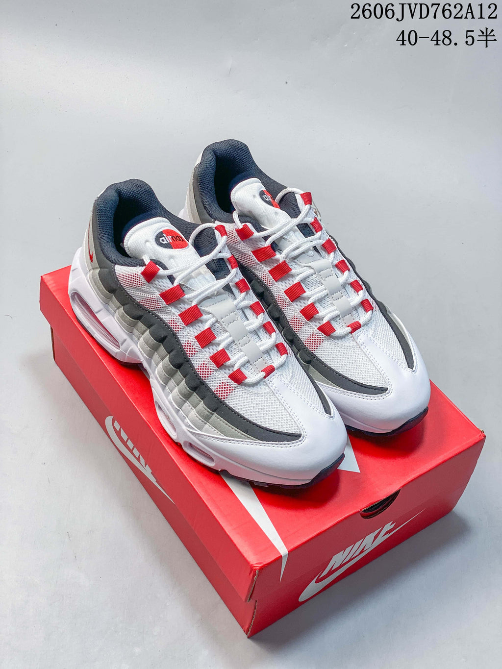 Pair of white, gray, and red Nike Air Max 95 OG sneakers shown on a red shoe box; image text states a size range of 40–48.5.