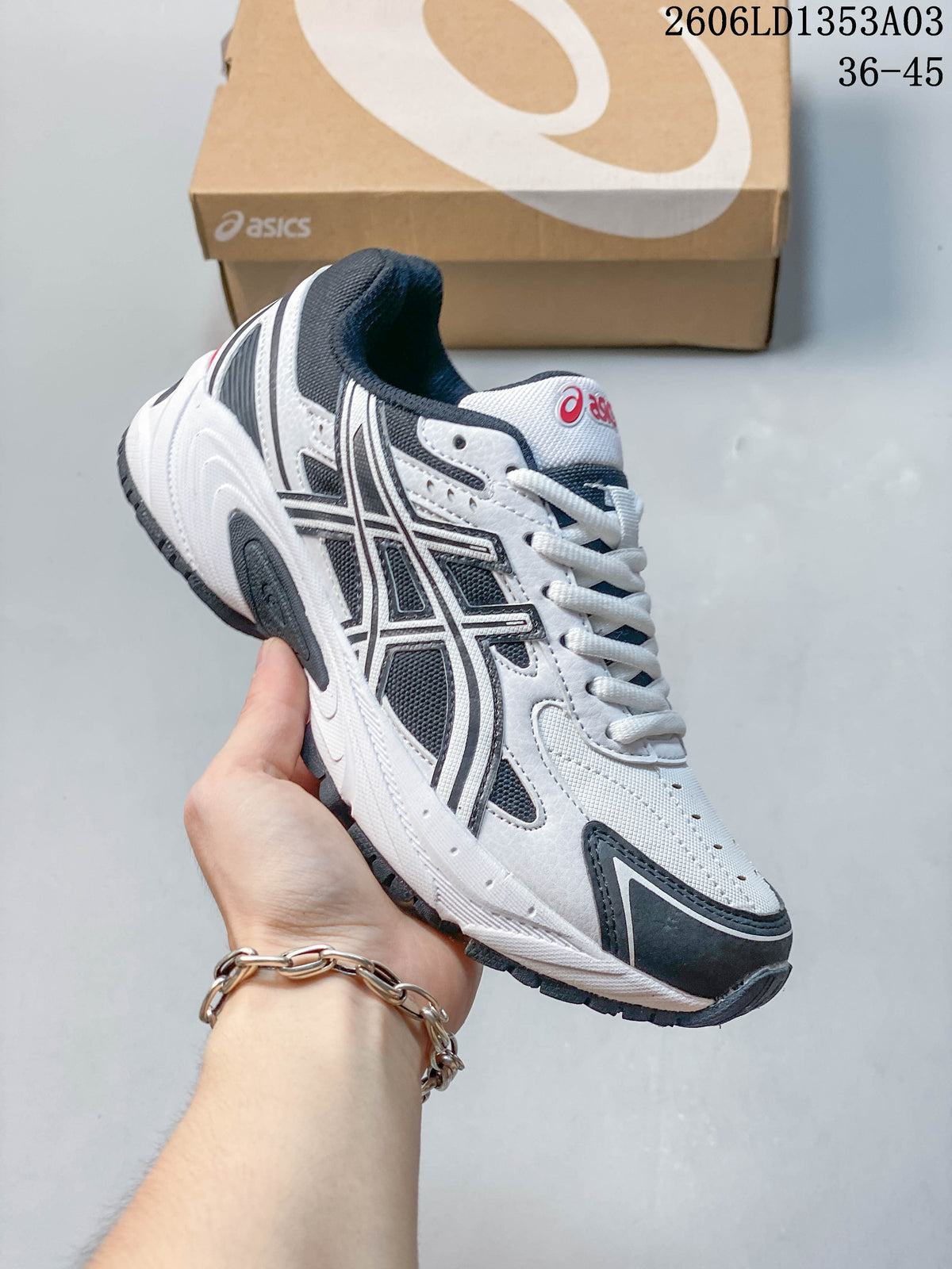 Angled side view of the white, navy, and gray GEL-170TR sneaker.