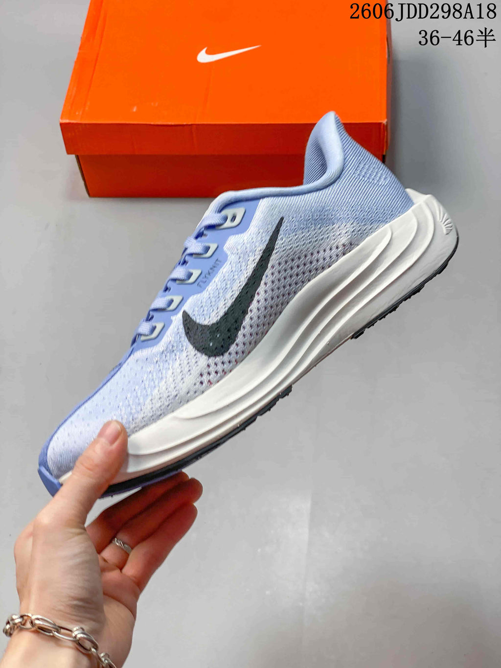 Side view showing the dark Swoosh, blue mesh upper and sculpted midsole