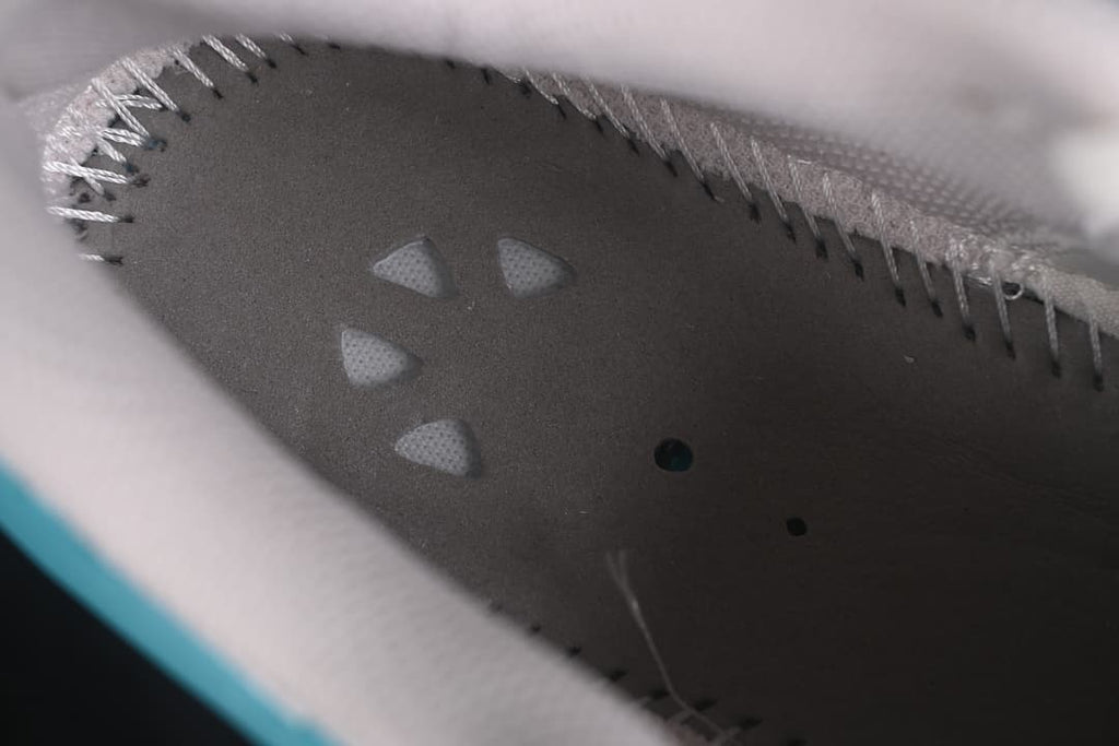 Close-up of the interior footbed and stitched textile lining.