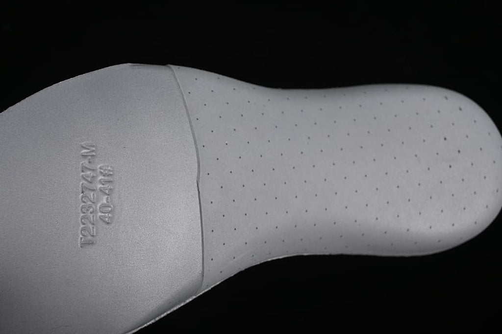 Close-up of a perforated footbed with a size marking.