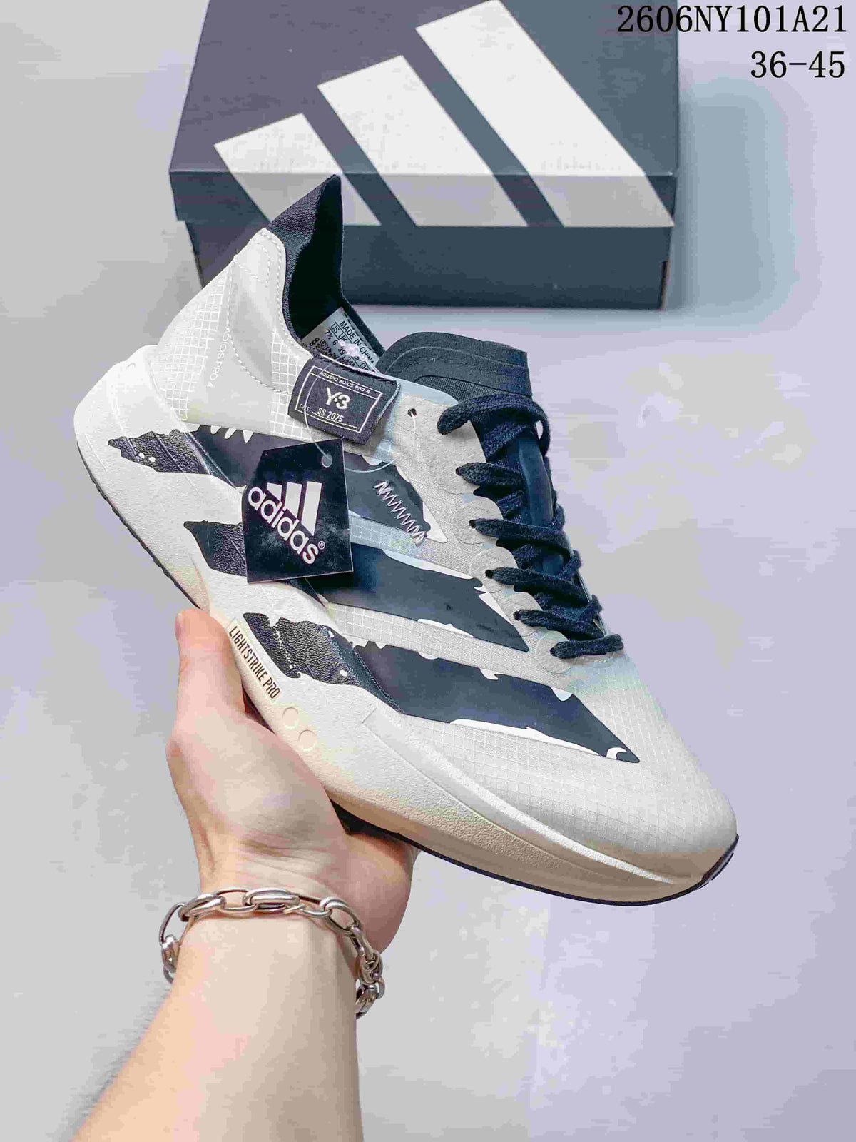 White Adidas running shoe with dark jagged side accents and Lightstrike Pro sole; image text shows 36–45.