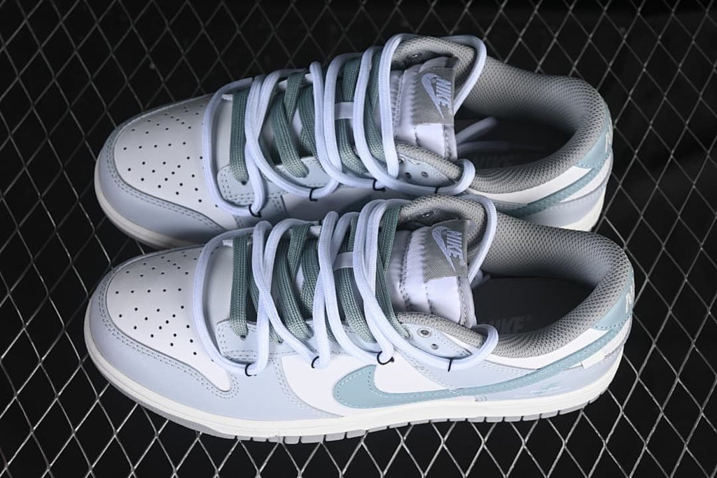 Pair of white and light blue low-top sneakers viewed from above